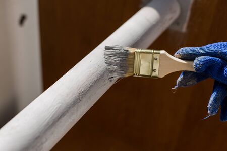 painter paints a tree with a brush with gloveの写真素材