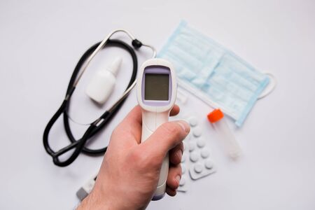 electronic thermometer in hand pills and maskの写真素材