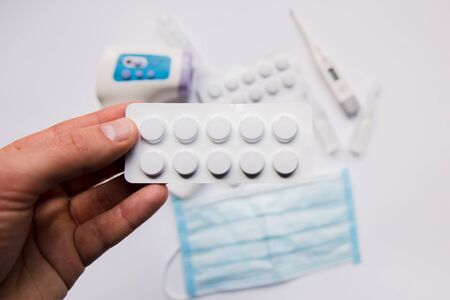 a plate with pills in hand and medicineの写真素材