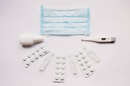 electronic thermometer with a medication and maskの写真素材