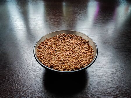 buckwheat in a pile on white backgroundの写真素材