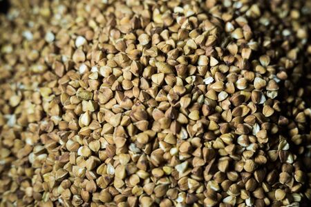 buckwheat in a pile on white backgroundの写真素材
