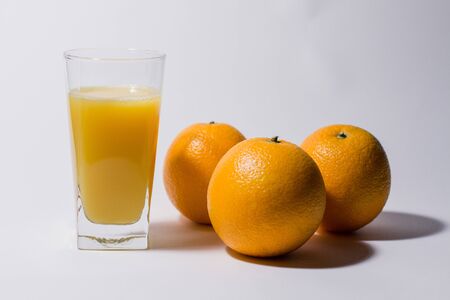 orange and juice on white backgroundの写真素材