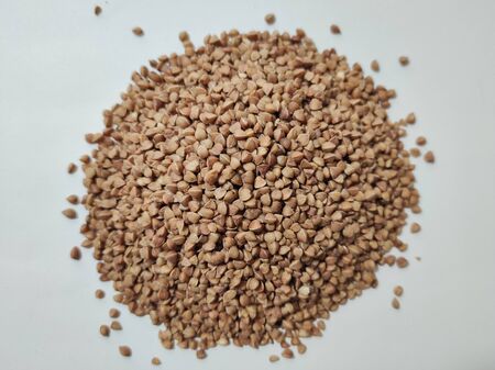 buckwheat in a pile on white backgroundの写真素材
