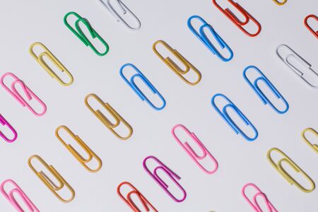 multicolored paper clips on white backgroundの写真素材