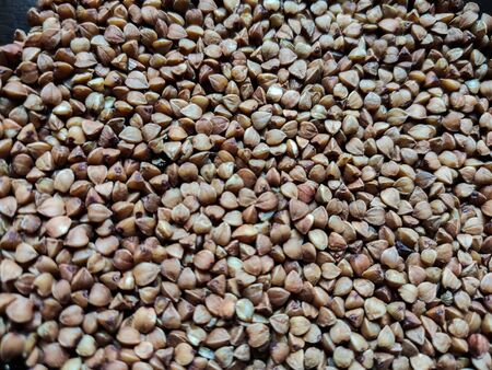 buckwheat in a pile on white backgroundの写真素材