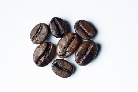 roasted coffee grains on a white backgroundの写真素材
