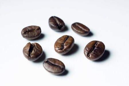 roasted coffee grains on a white backgroundの写真素材