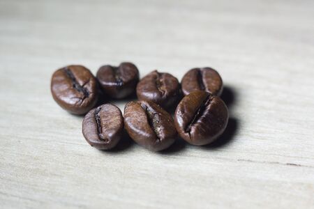 roasted coffee grains on a white backgroundの写真素材