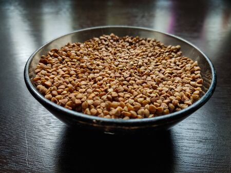 buckwheat in a pile on white backgroundの写真素材