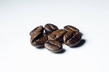 roasted coffee grains on a white backgroundの写真素材