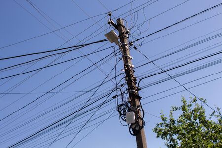 an electric wires on a pillar in a city