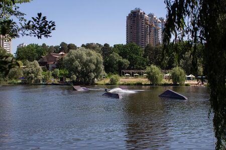 a big lake in the park against of the cityの写真素材
