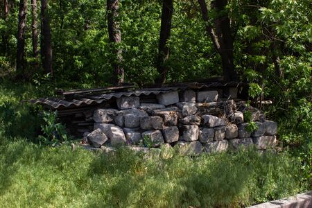 pieces of concrete lie in forest in summerの写真素材