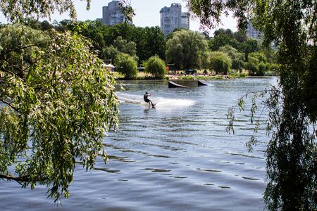man on wakeboard on a lakeの写真素材