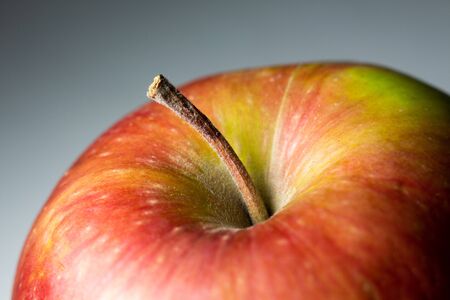 ripe apple close-up on gray backgroundの写真素材