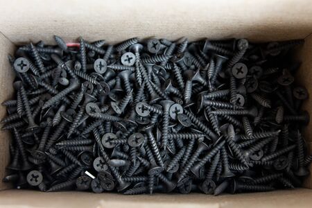 black screws in cardboard box