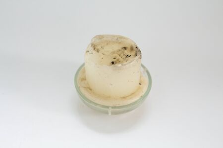 old white candle on white backgroundの写真素材