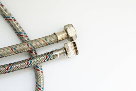 old metal water hose on white backgroundの写真素材