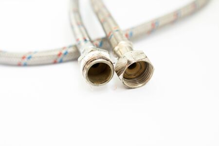 old metal water hose on white backgroundの写真素材