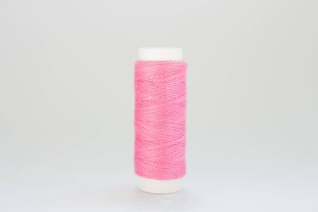 pink threads on white backgroundの写真素材