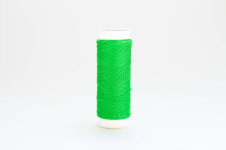 skein of green thread on white background