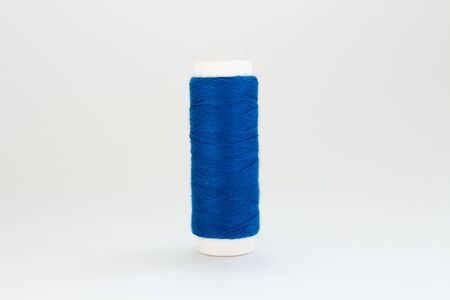 spool of blue thread on white backgroundの写真素材