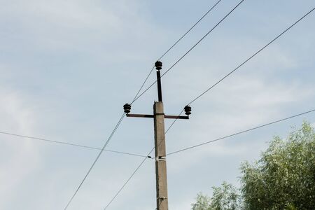 pole with electric wires in villageの写真素材