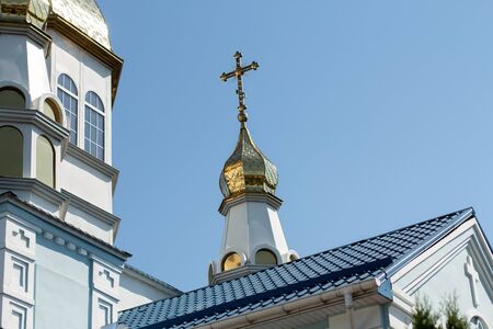 golden domes of the church against blue skyの写真素材