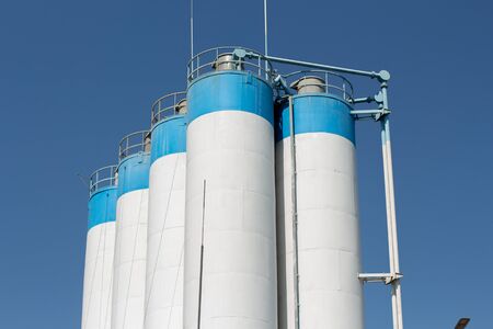 a tall factory barrels and blue skyの写真素材