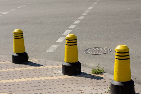 a boundary posts on the sidewalkの写真素材