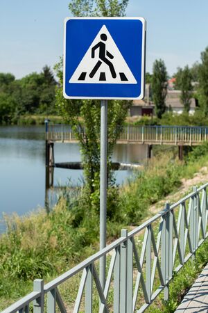 pedestrian crossing sign near lakeの写真素材