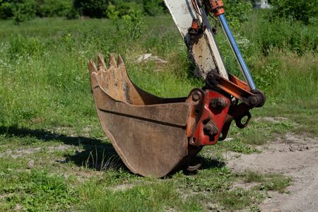 old tractor bucket on grassの写真素材