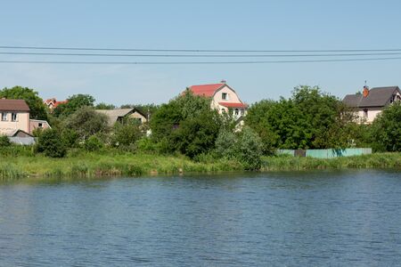 private houses over lake in the forestの写真素材