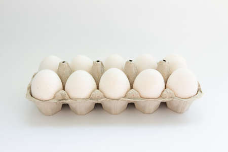 eggs in a tray on white backgroundの写真素材