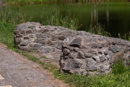 stone fence in green parkの写真素材