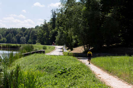 child runs in park along the roadの写真素材