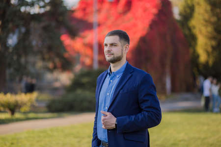 man in suit in the autumn in the parkの写真素材
