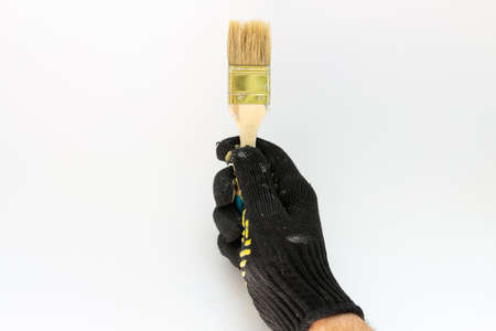painter brush in hand on white backgroundの写真素材