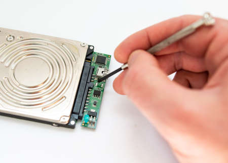a man repairs hard driveの写真素材