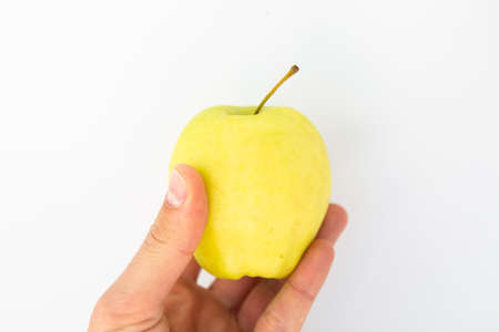 apple in hand on white backgroundの写真素材