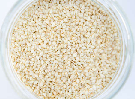 sesame in a jar on white backgroundの写真素材
