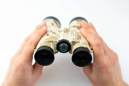 binoculars in hands on white backgroundの写真素材