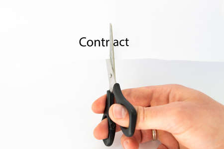 scissors in the hands of a man and white sheet