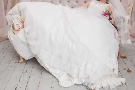 bride holding wedding bouquet in a dressの写真素材