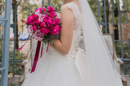 bride holding wedding bouquet in a dressの写真素材
