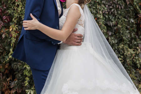 bride and groom together in park at the weddingの写真素材