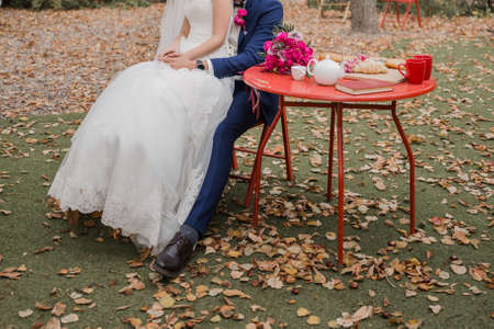 bride and groom together in park at the weddingの写真素材