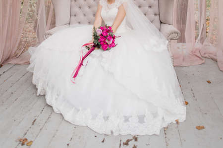 bride holding wedding bouquet in a dressの写真素材
