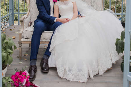bride and groom together in park at the wedding